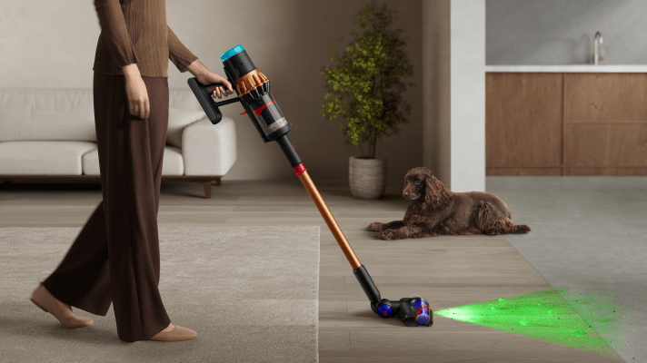 Woman using Dyson wet floor cleaner to clean spill on the floor