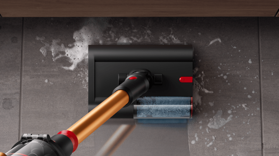 Dyson wet and dry vacuum cleaner is used to clean a pill on the tile floor.